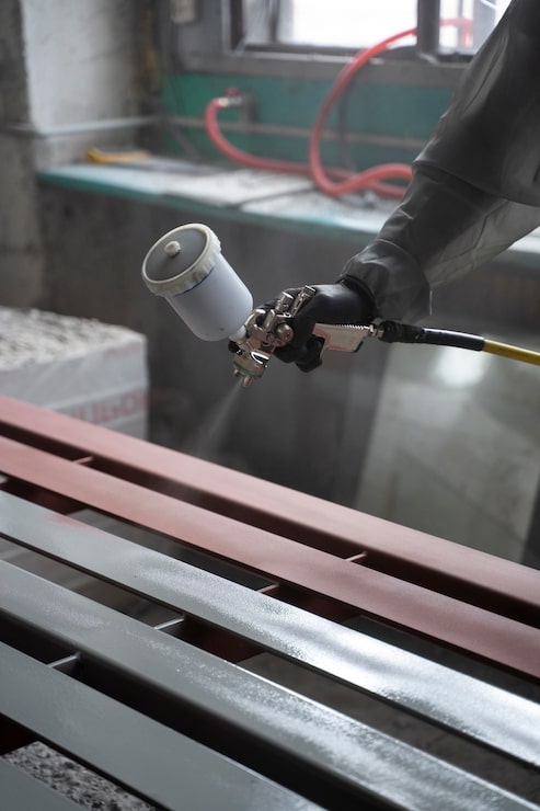 side-view-hand-spraying-powder-paint-from-gun_23-2149878760